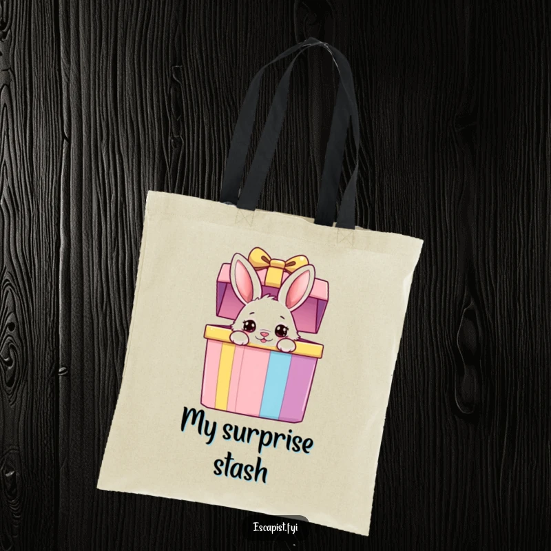 Funny bunny tote bag depicting a fluffy bunny peeking from a colorful gift box with wide, curious eyes, ideal for shopping and carrying items.